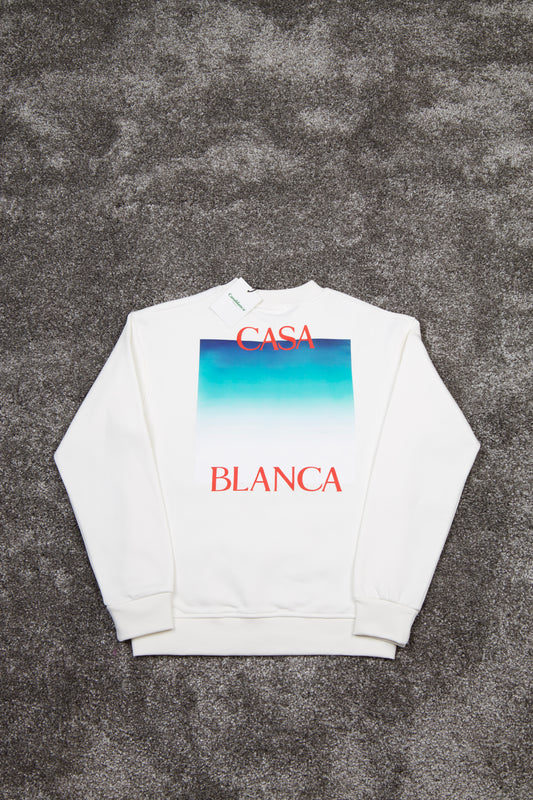 White sweatshirt with 'Casa Blanca' text and gradient design on a textured gray background